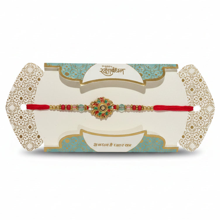 Decorative red bracelet with green stones on a decorative card against a black background